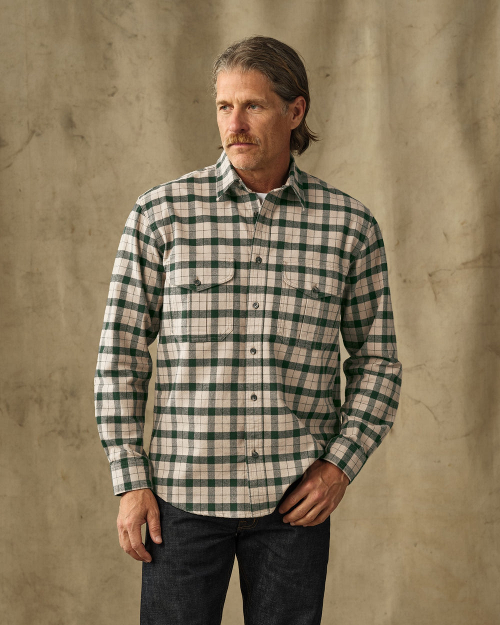 image of a model wearing Filson's Alaskan Guide Shirt - Oatmeal / Pine Plaid