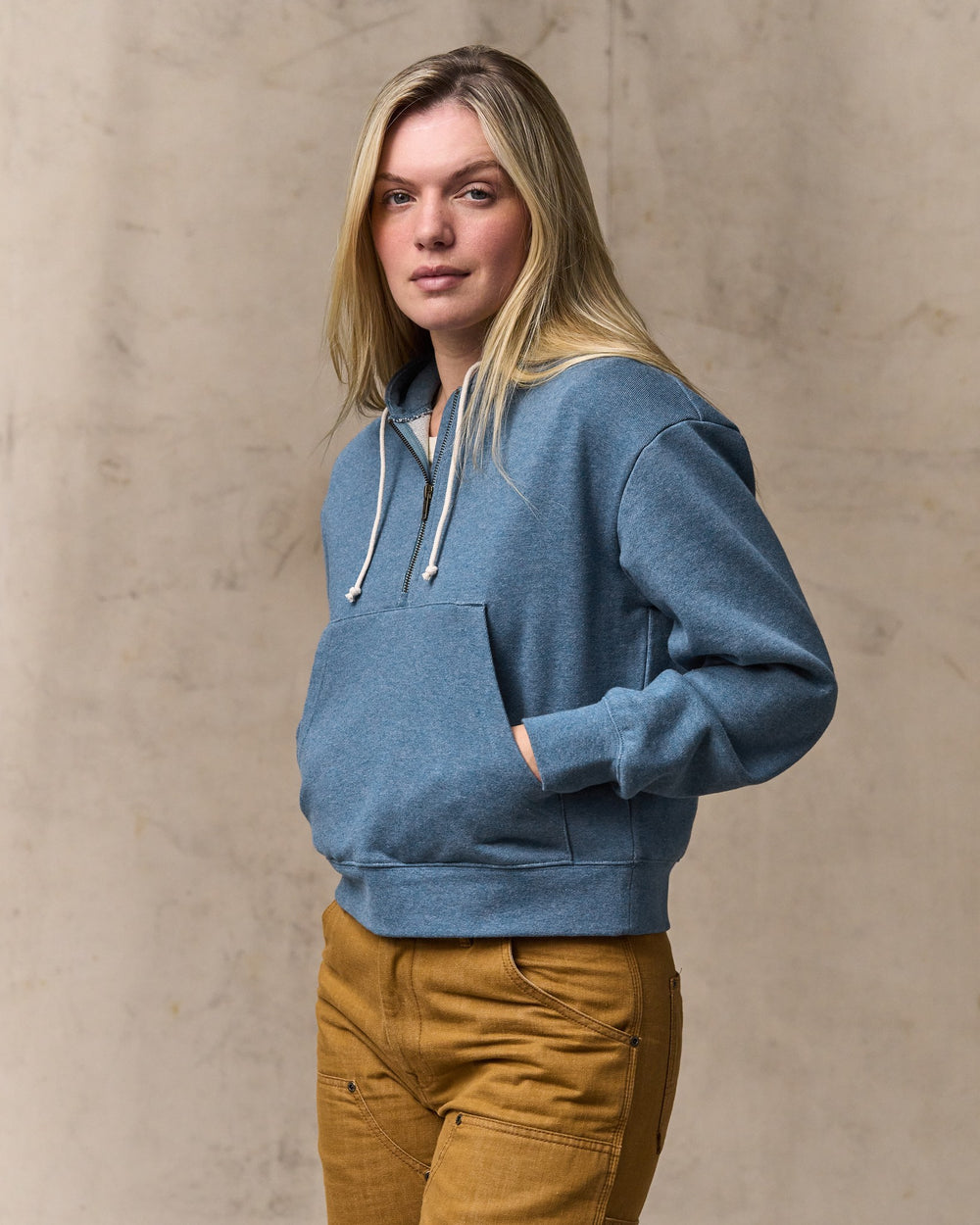 image of a model wearing Filson's Women's French Terry Half-zip Hoodie - Light Blue
