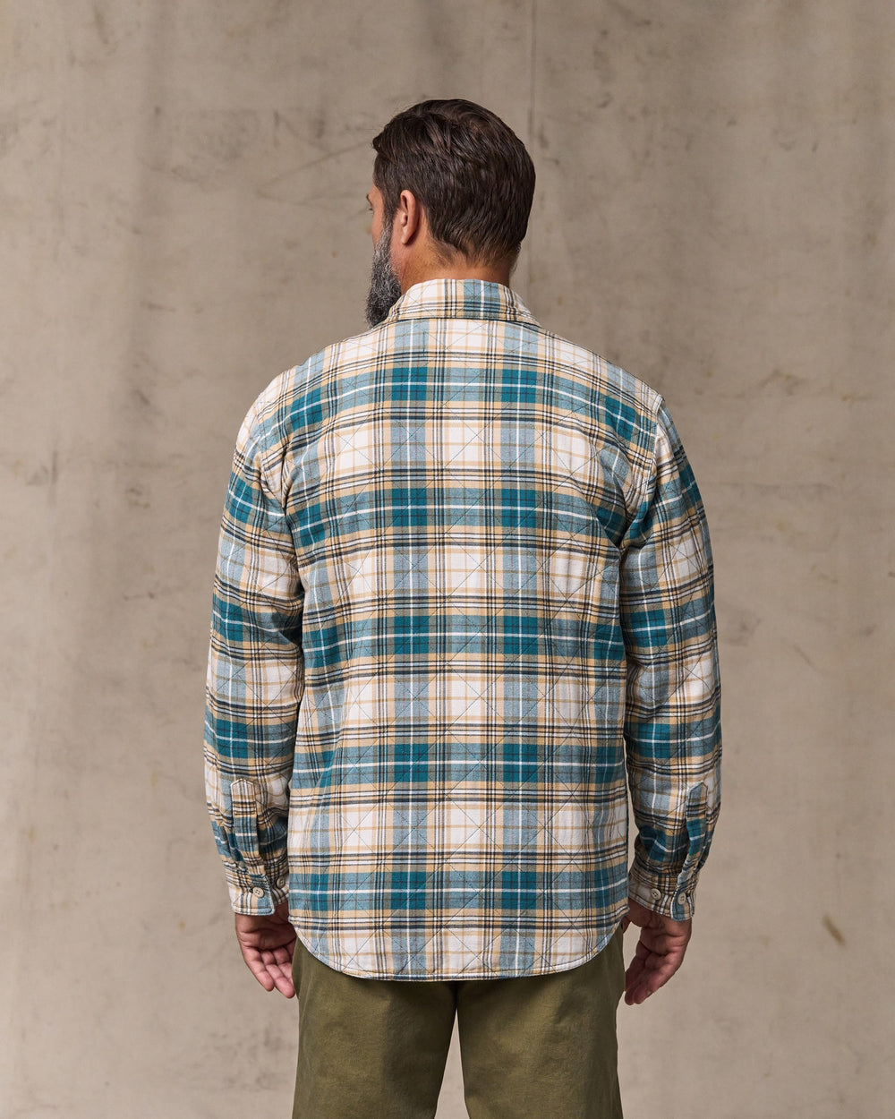 image of a model wearing Filson's Insulated Flannel Jac-shirt - Teal / Khaki Plaid