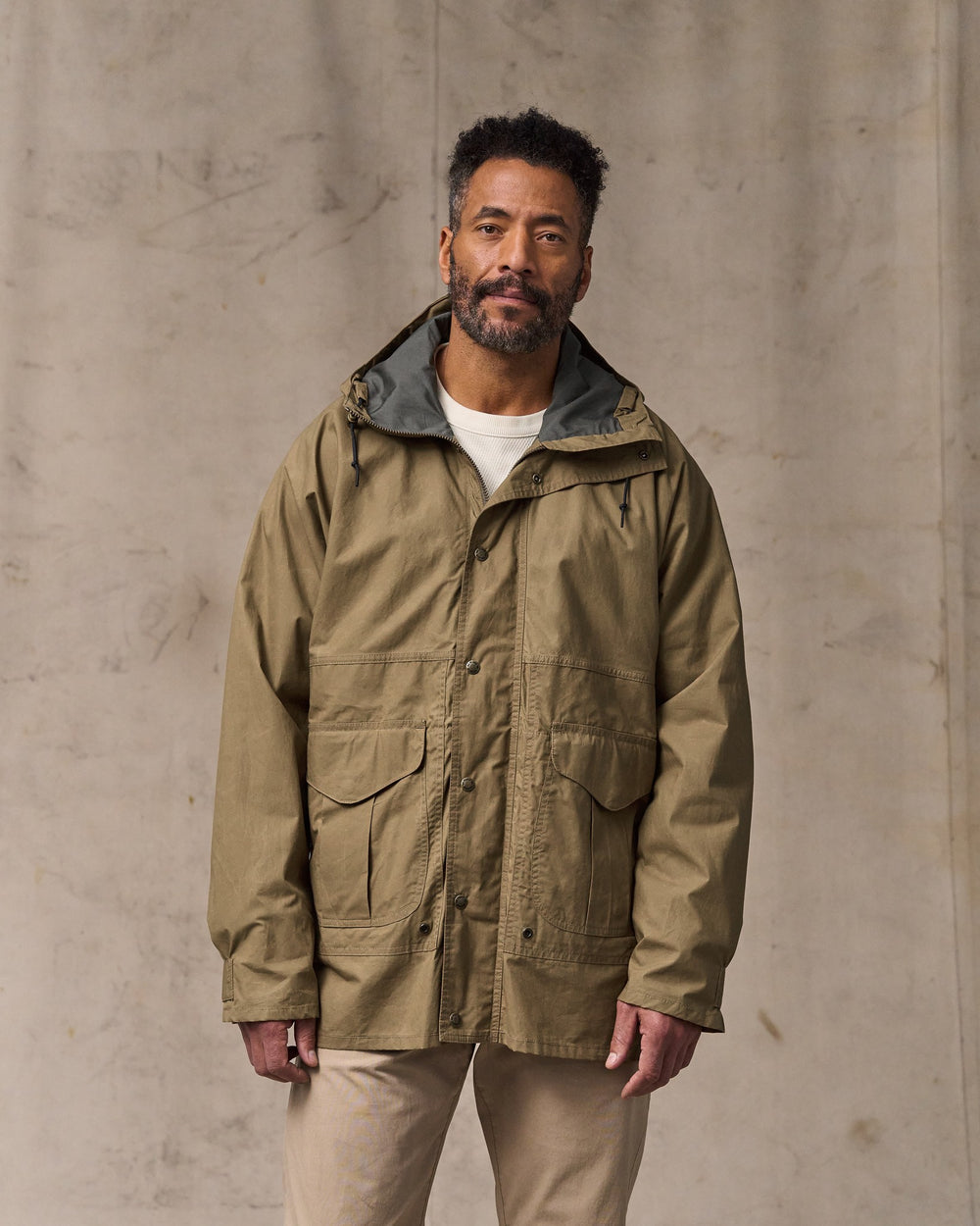 image of a model wearing Filson's Dry Wax Omak Coat - Dark Beige