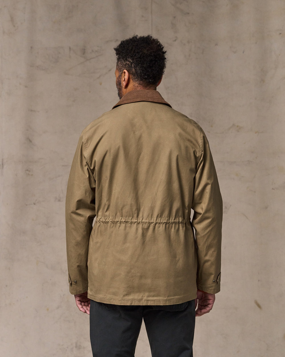 image of a model wearing Filson's Dry Wax Mile Marker Coat - Dark Beige