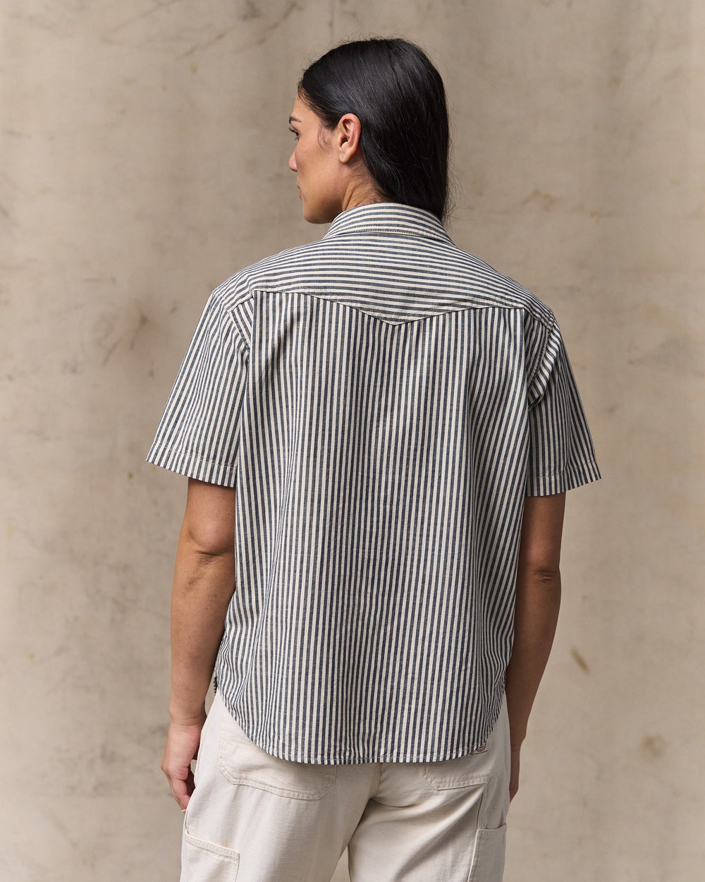 image of a model wearing Filson's Women's Short Sleeve Chambray Western Shirt - Indigo / Natural