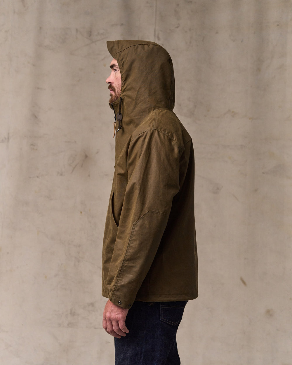 image of a model wearing Filson's Shelter Cloth Waxed Anorak - Dark Tan